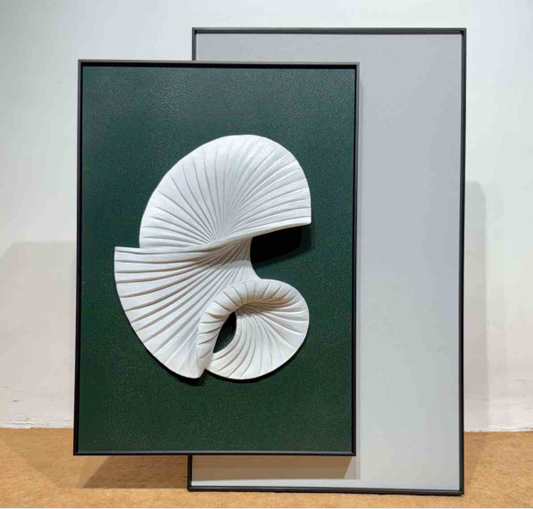 Framed artwork of a white shell design on a green background
