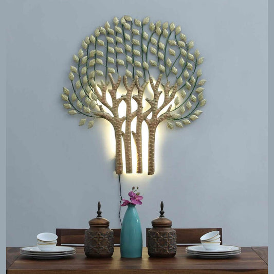 Decorative wall light shaped like a tree with a dining table and decor items below.