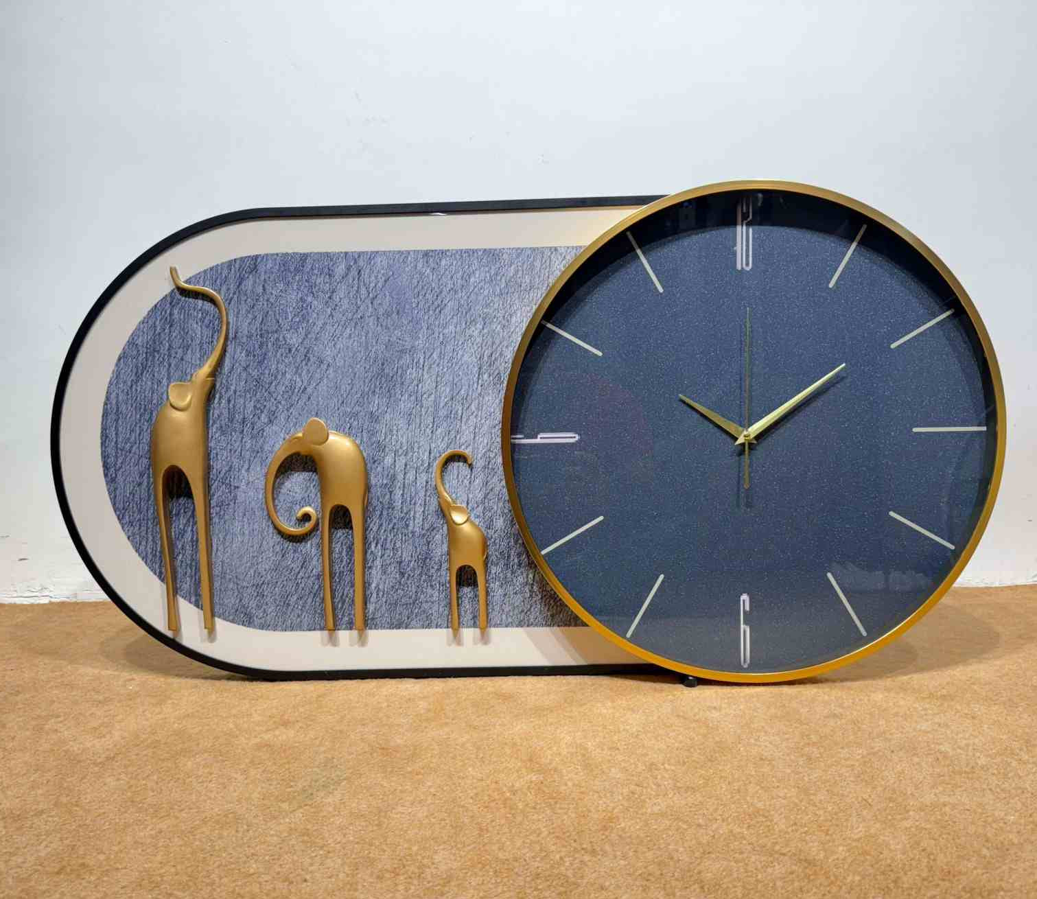Decorative wall clock with gold animal figures on a blue background