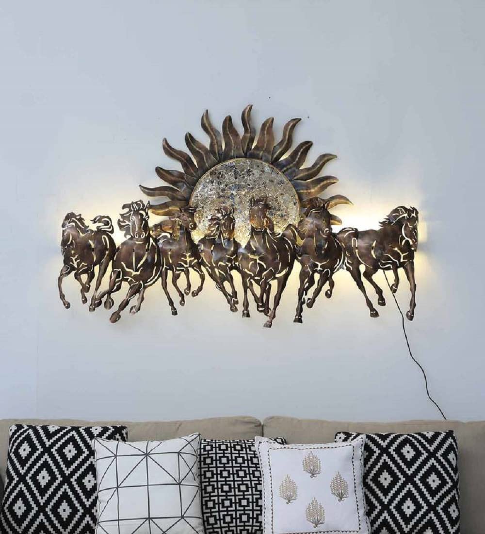 Decorative wall art with horses and a sun design on a light gray wall above a sofa.