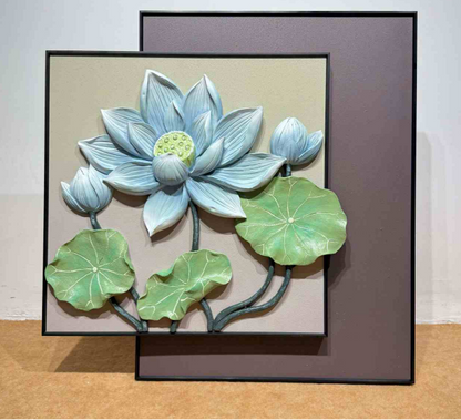 Decorative wall art of a blue lotus flower with green leaves on a beige background.