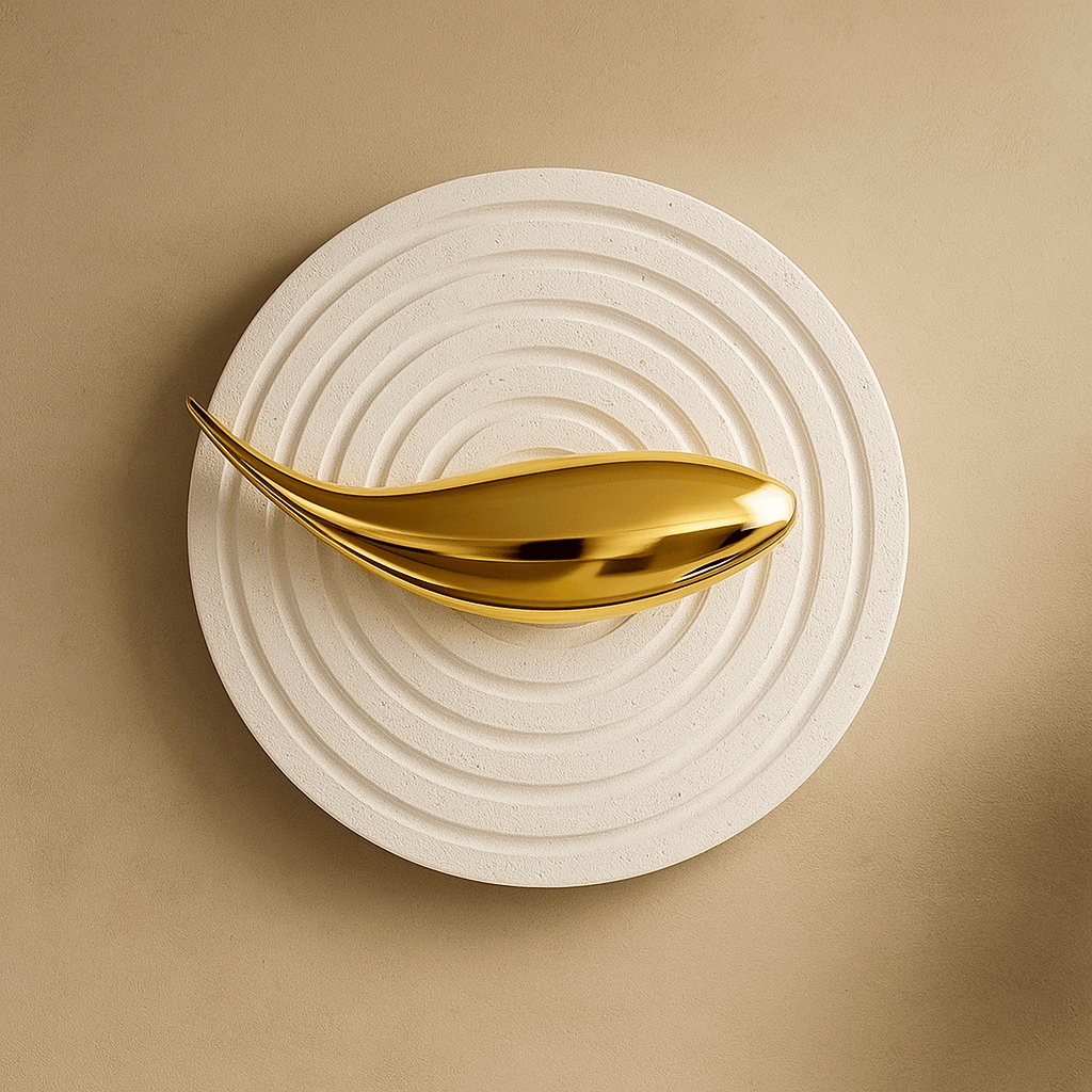 Gold decorative object on a textured beige surface