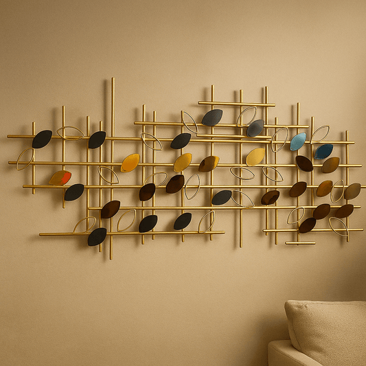 Decorative wall art with gold frame and multicolored leaves on a beige wall.