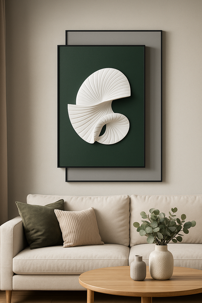Framed artwork of a shell on a wall above a beige sofa with decorative pillows and a small table.