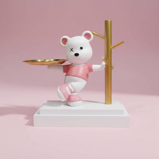 White bear figurine with pink shirt and shoes holding a gold tray on a pink background