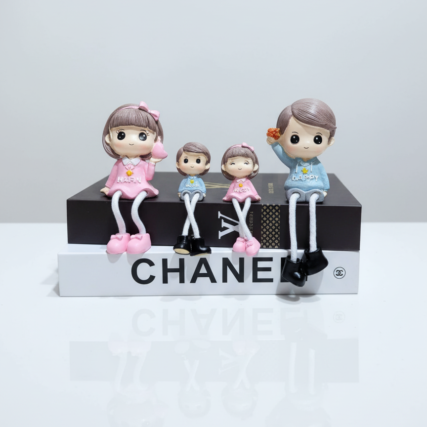 Set of four figurines on a Chanel box with a white background